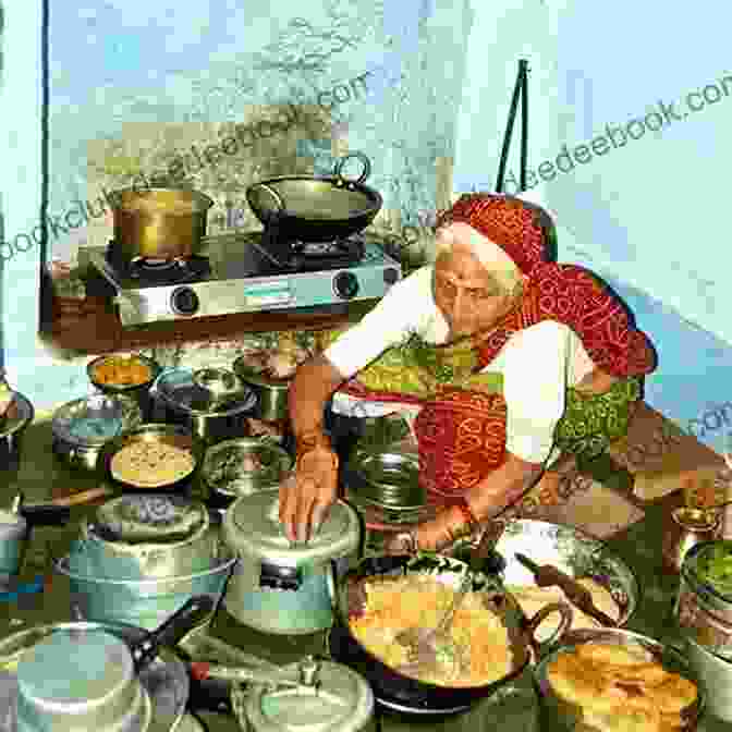 A Woman Gracefully Preparing Spices In A Traditional Indian Kitchen, Surrounded By Vibrant Fabrics And Utensils. Stirring The Pot Quraisha Dawood